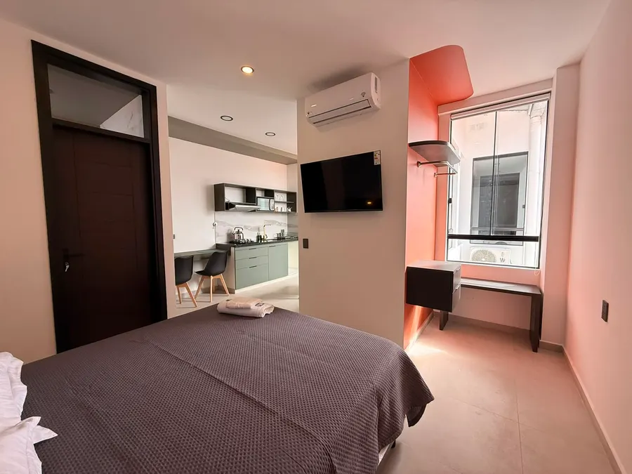 Dormitorio con escritorio junto a la ventana